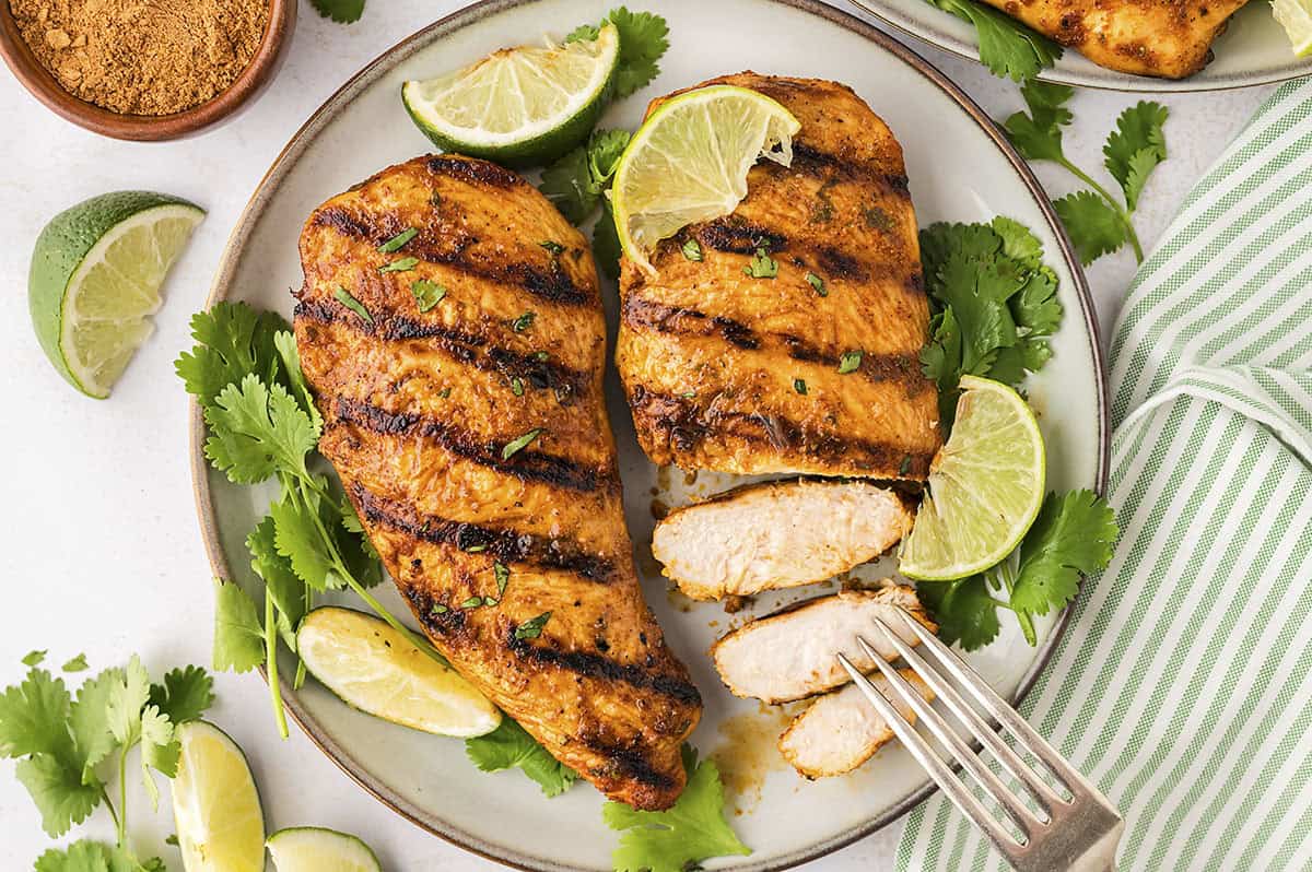 Sliced chicken breasts on plate.