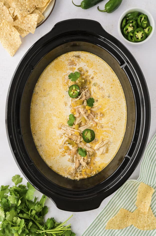 Crockpot white chicken chili topped iwth cheese and jalapeno.