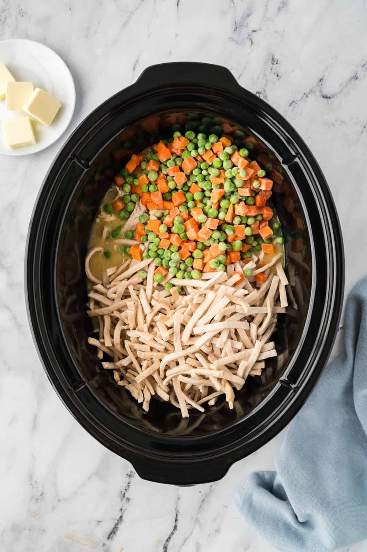 Noodles and vegetables in crockpot.