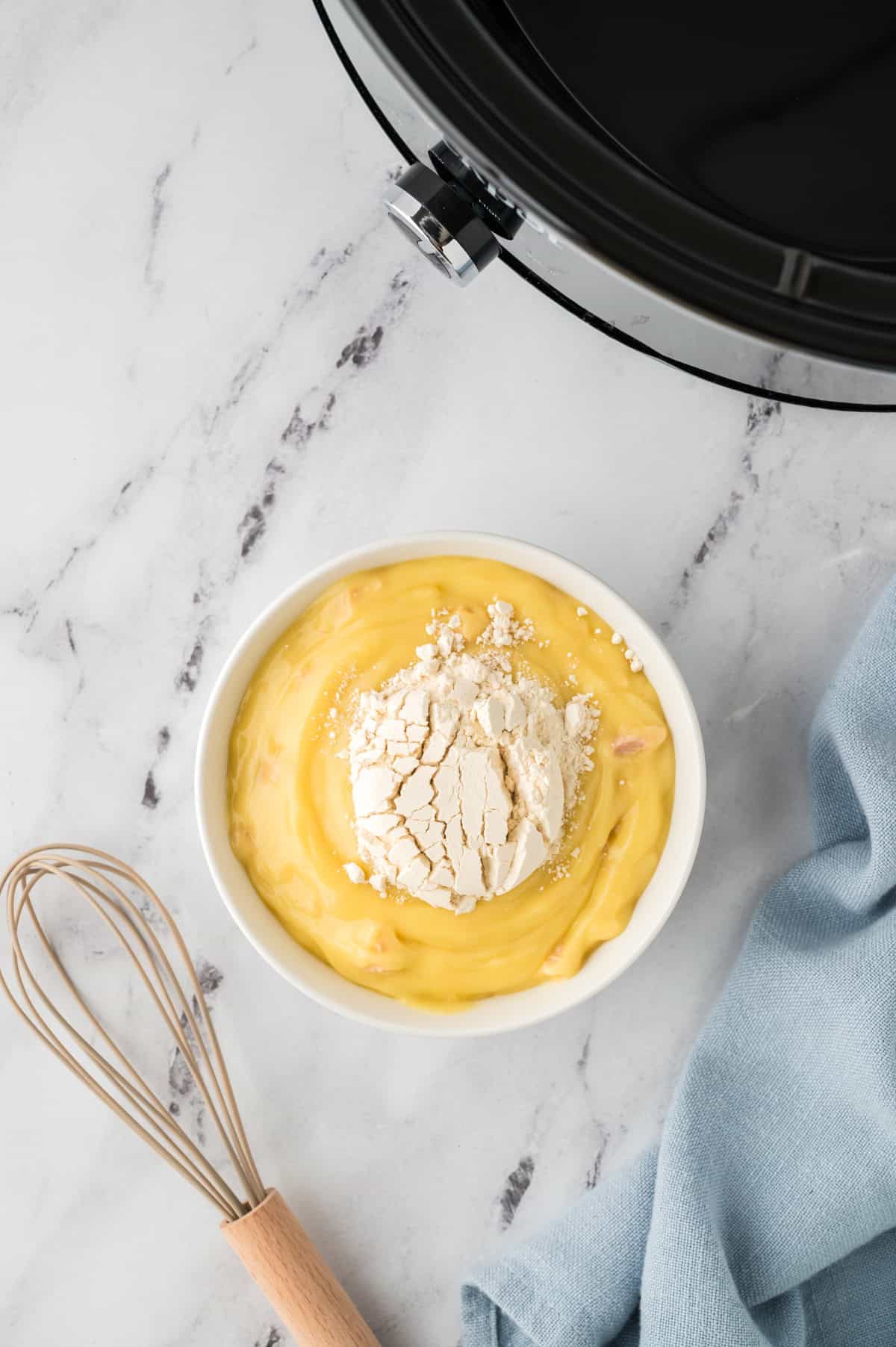 Cream of chicken soup and gravy mix in bowl.