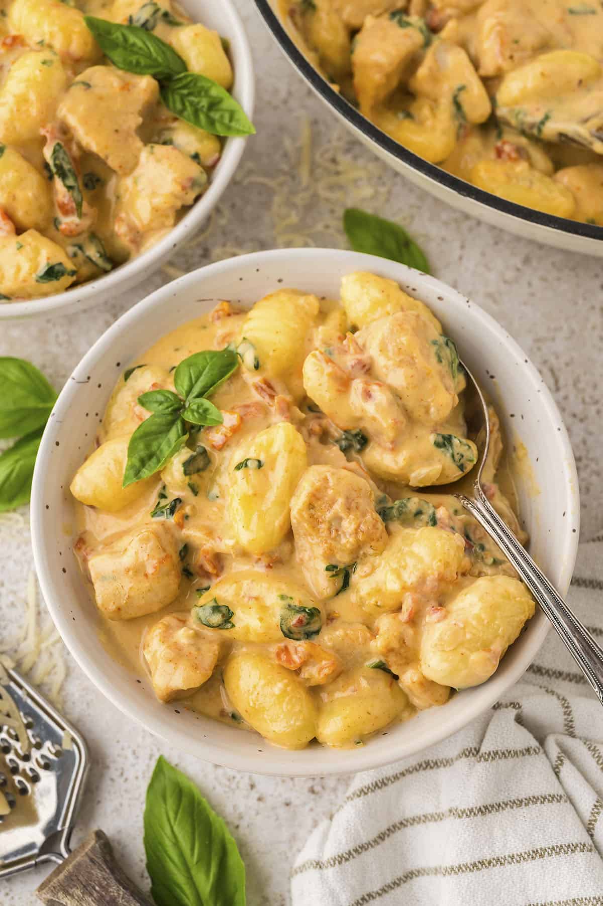 Bowl full of Tuscan chicken and gnocchi.