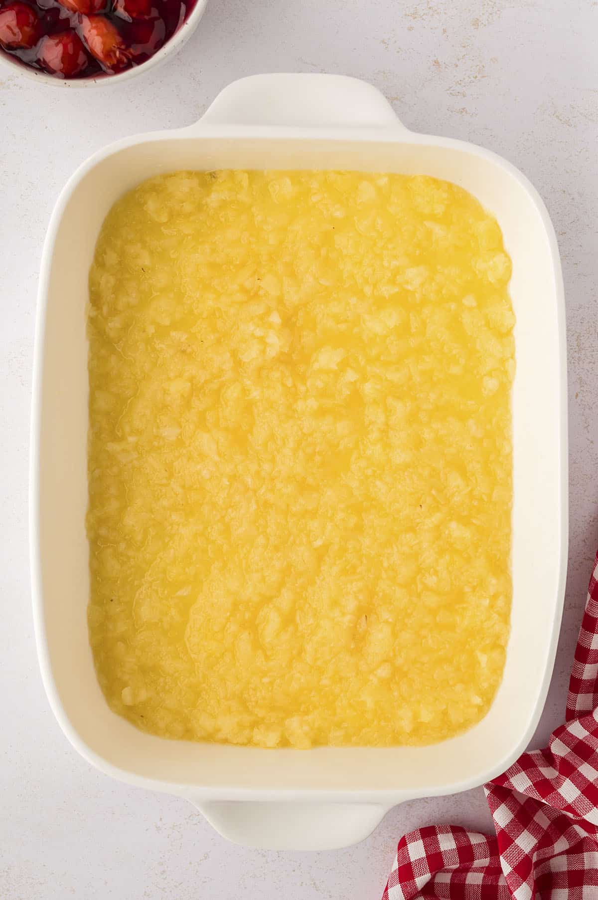 Crushed pineapple in baking dish.