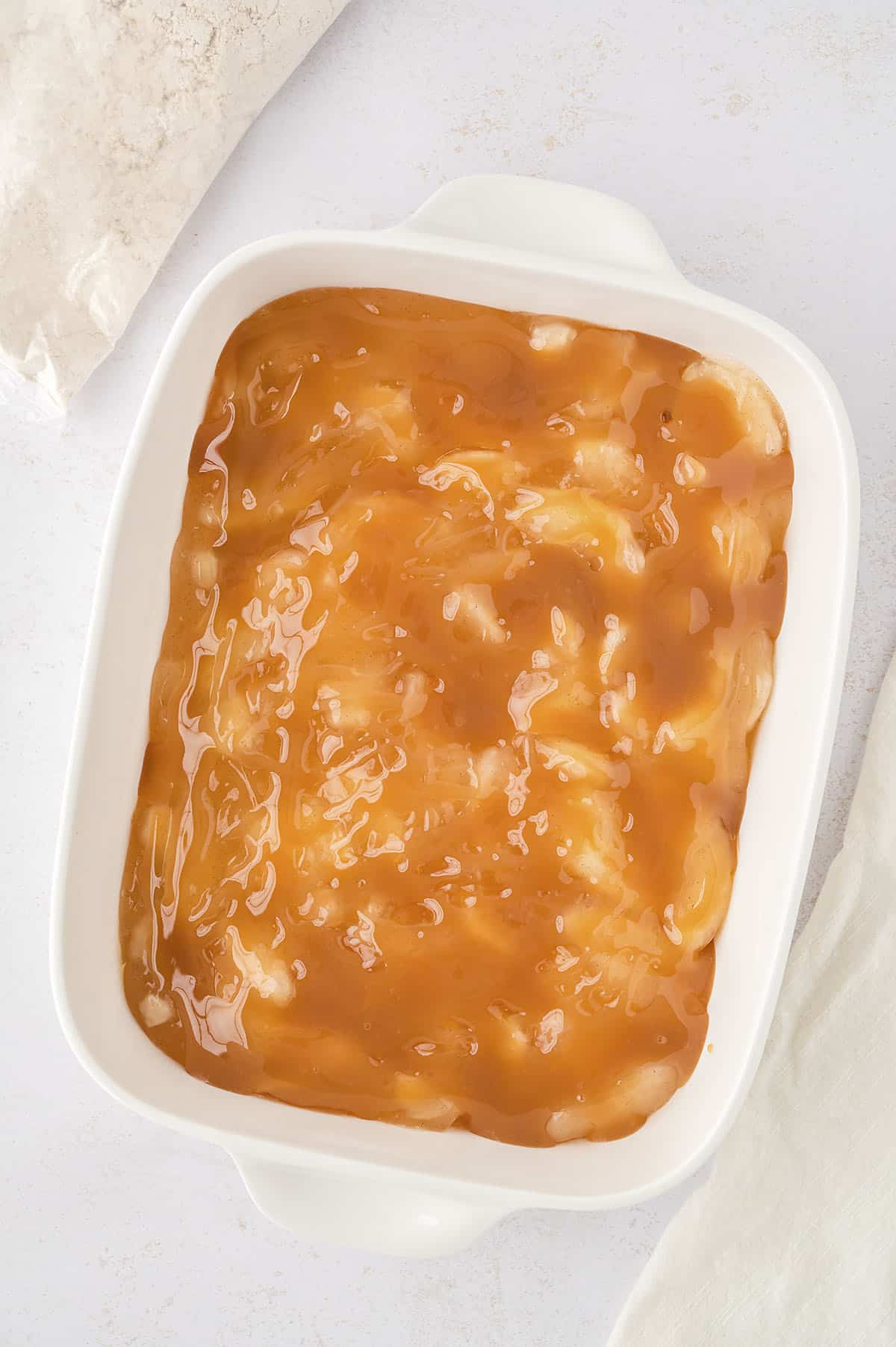 Caramel sauce spread over apple pie filling.