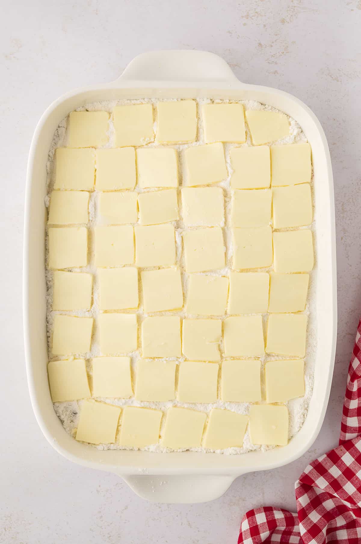 Slices of butter over a cake mix.