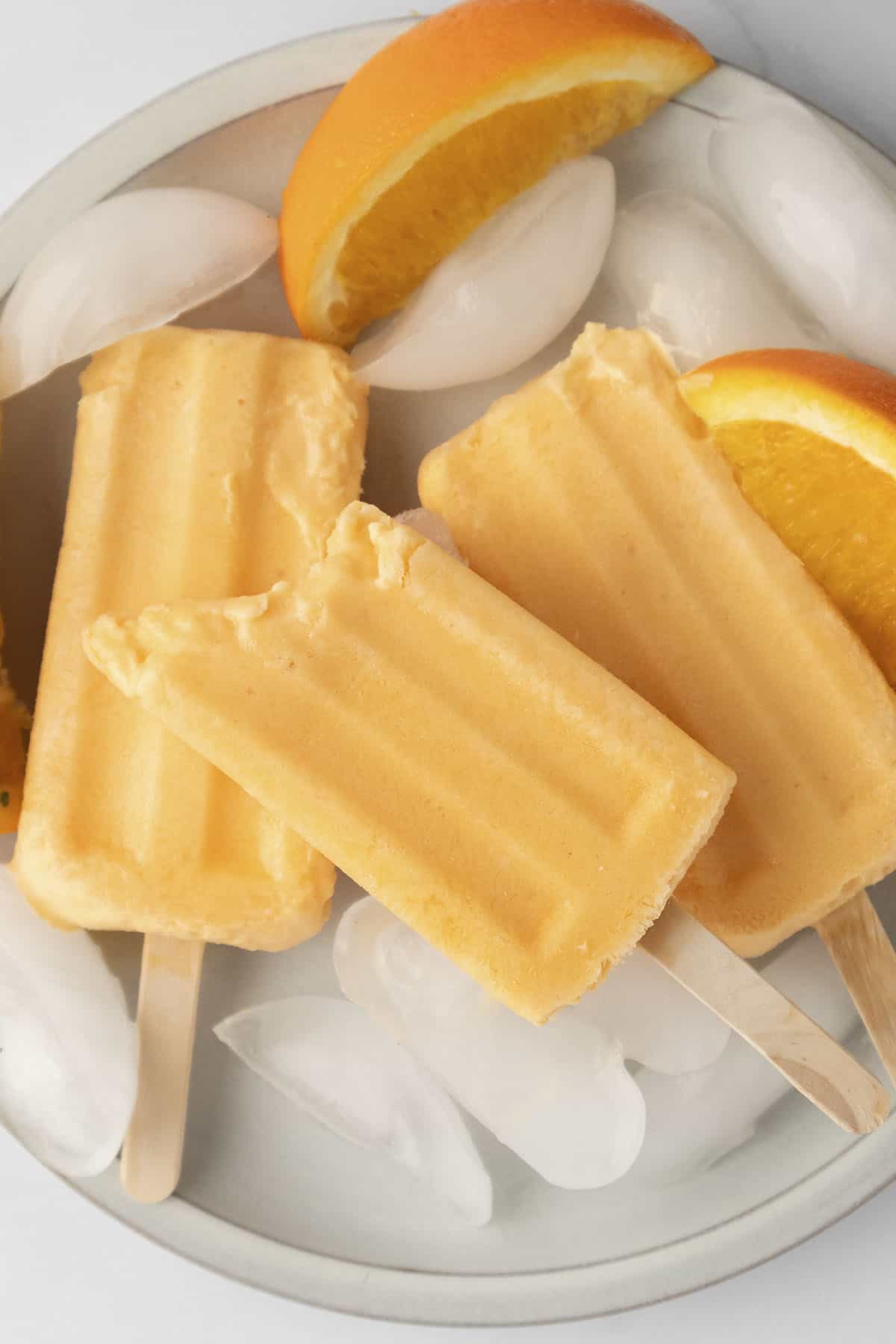 Orange cream popsicle with a bite taken out.