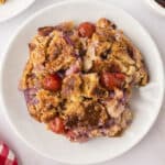 Pineapple cherry dump cake on small white plate.