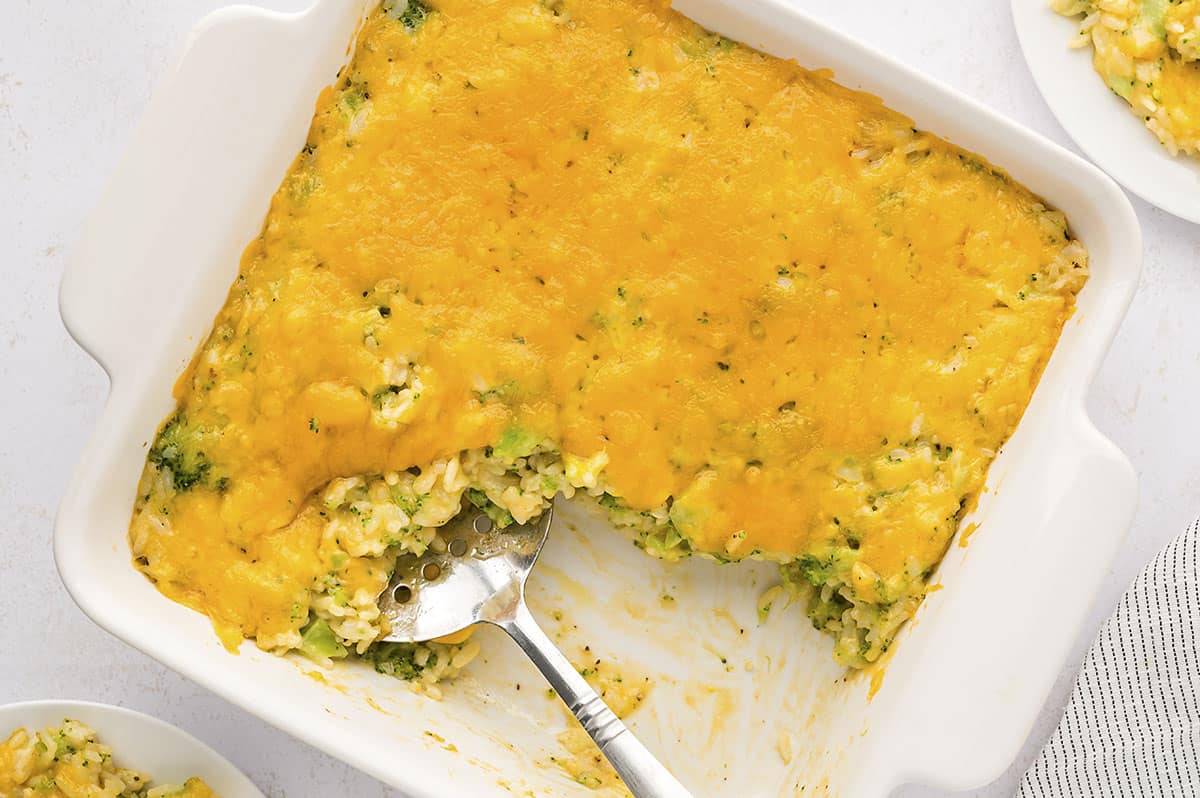 White baking dish full of broccoli casserole with rice.