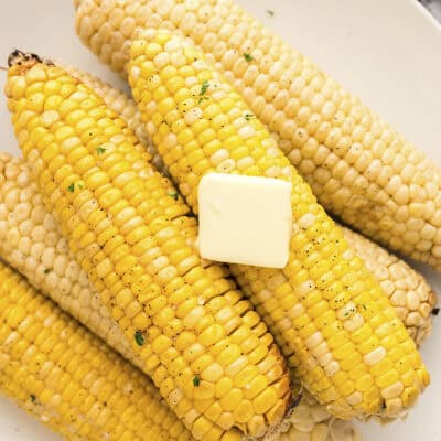 Crock Pot corn on the cob topped with butter.