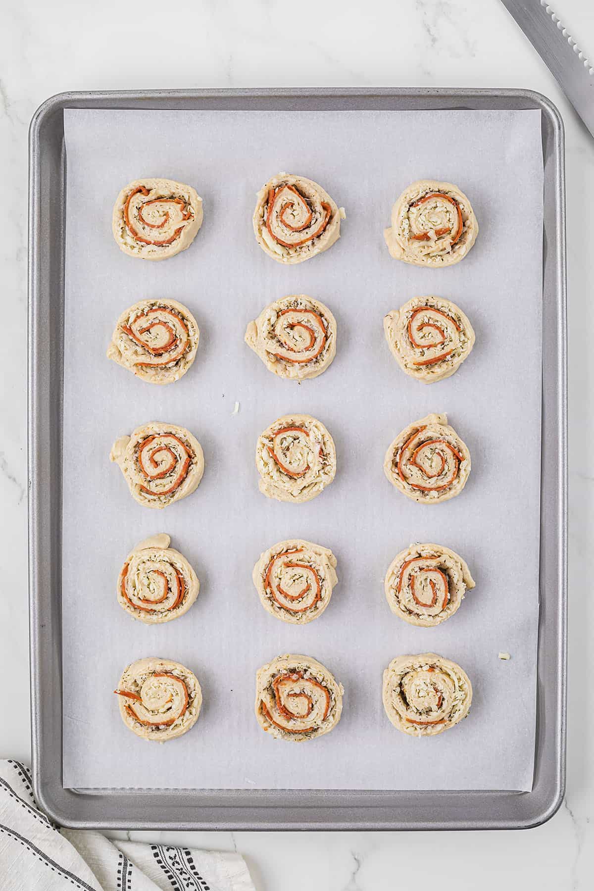 Pizza pinwheels on sheet pan.