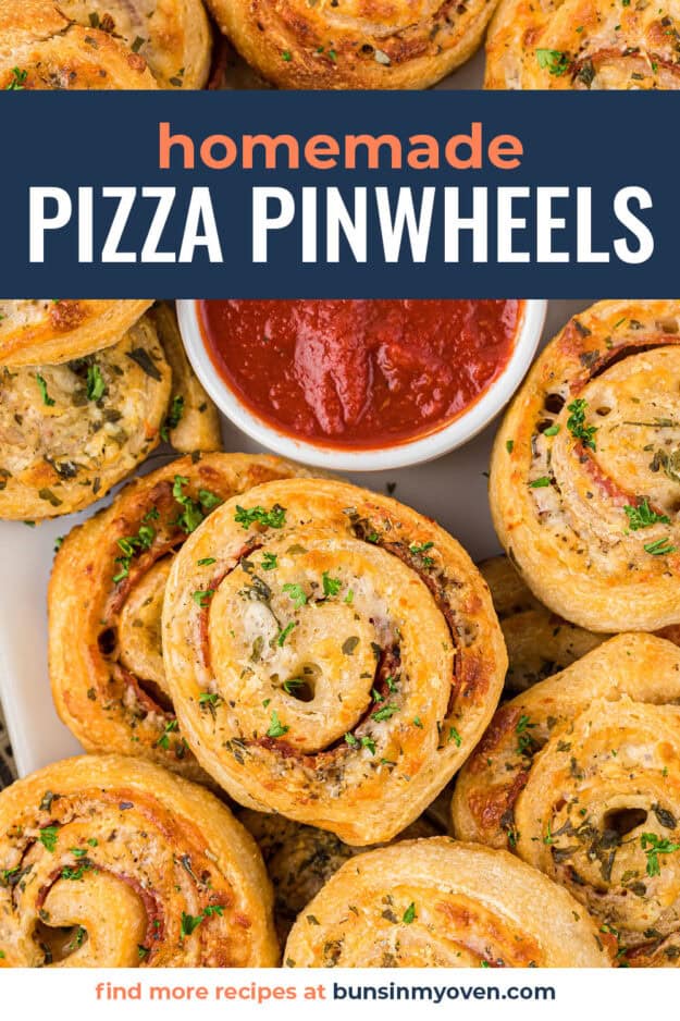 Pizza pinwheels surrounding a dish of pizza sauce.