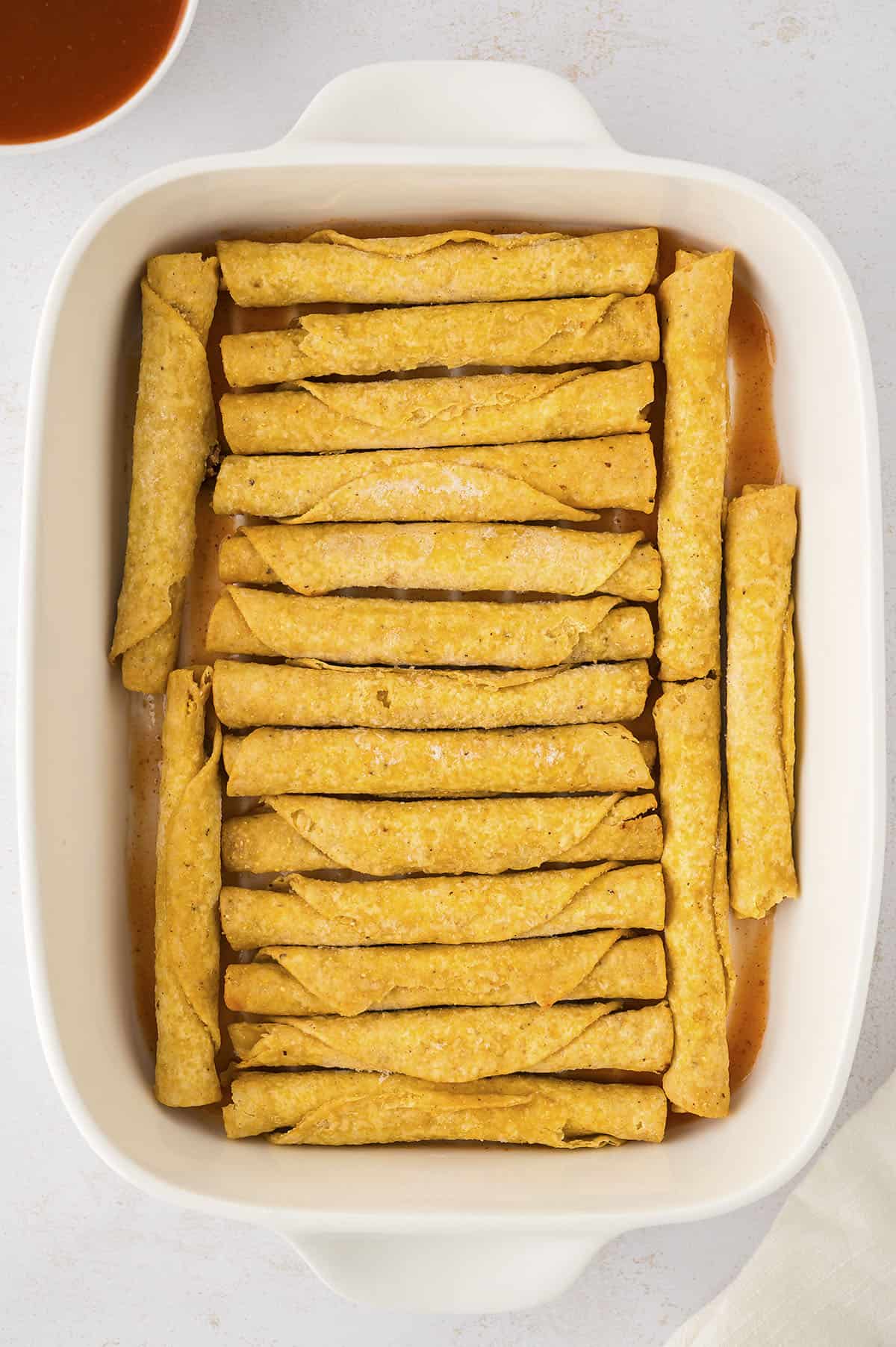 Taquitos in baking dish.