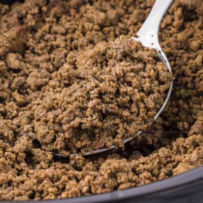 Ground beef on spoon in crockpot.