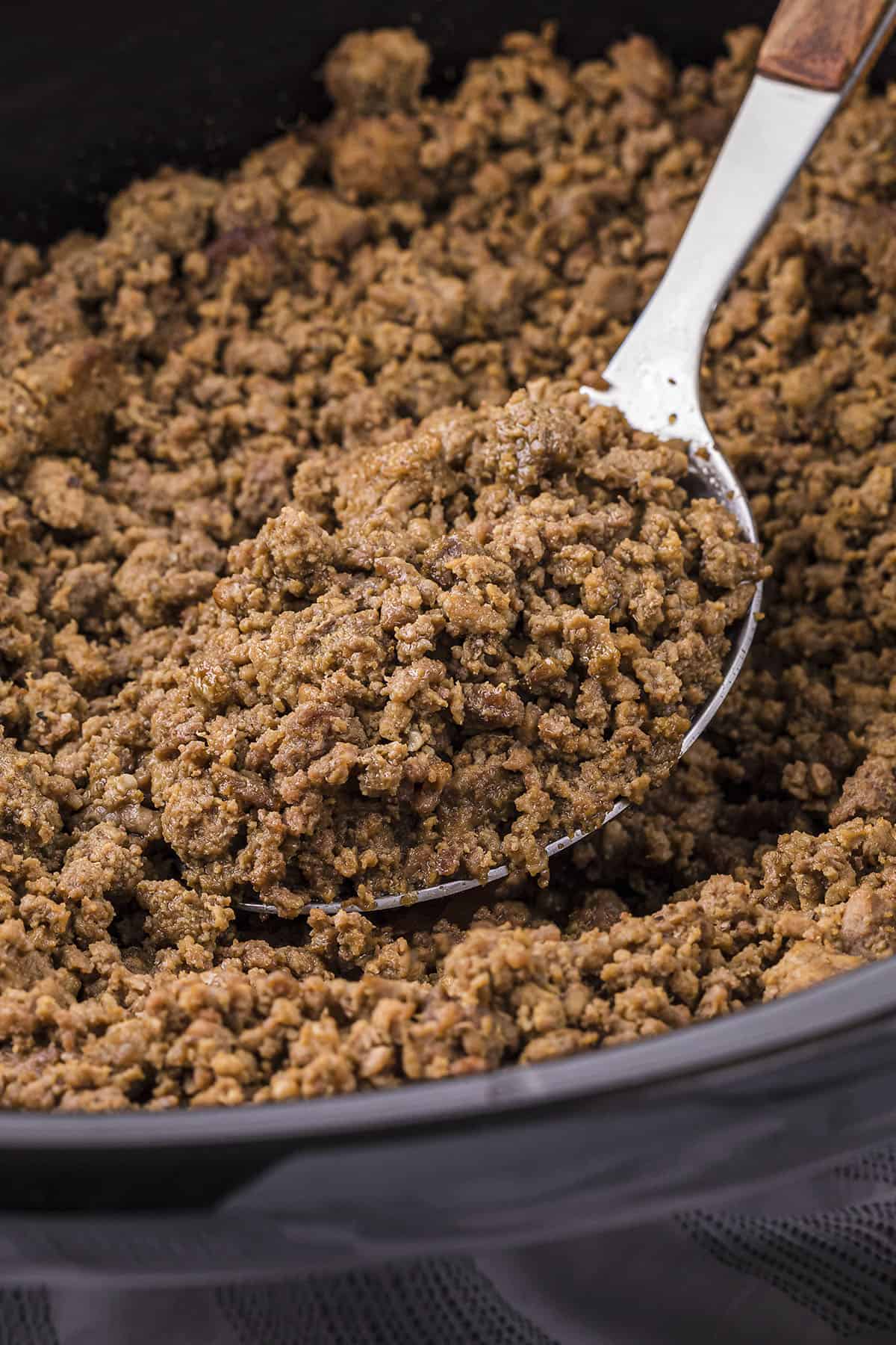 Ground beef on spoon in crockpot.