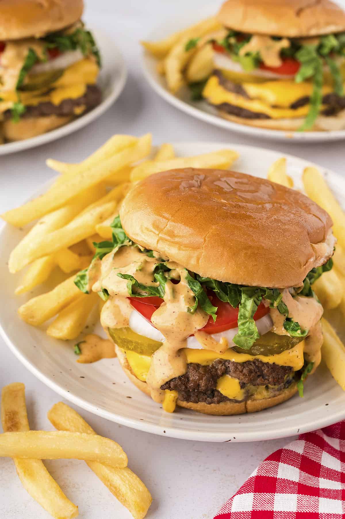 Smash burger recipe on plate with fries.