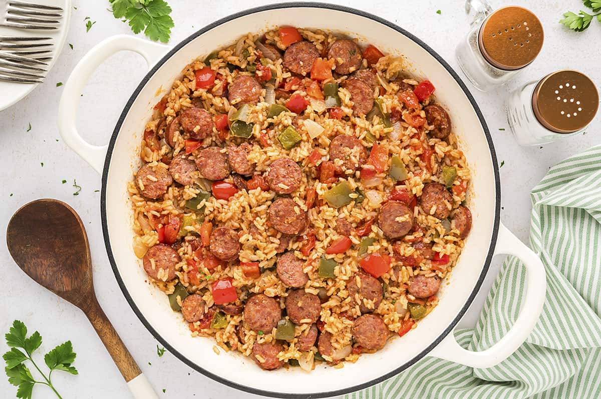 Skillet full of sausage, rice, and peppers.