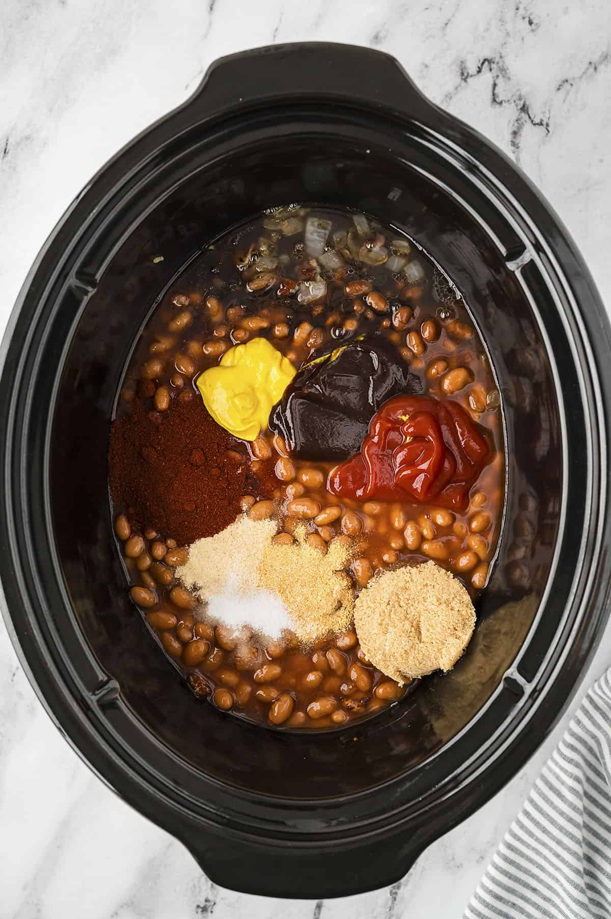 Beans and seasoning in crockpot.