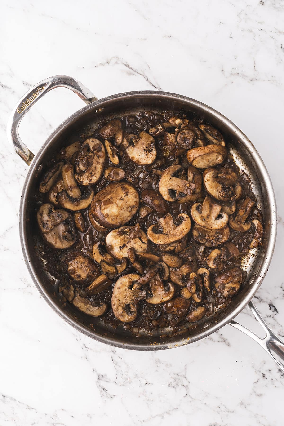 Mushrooms and onions in skillet.