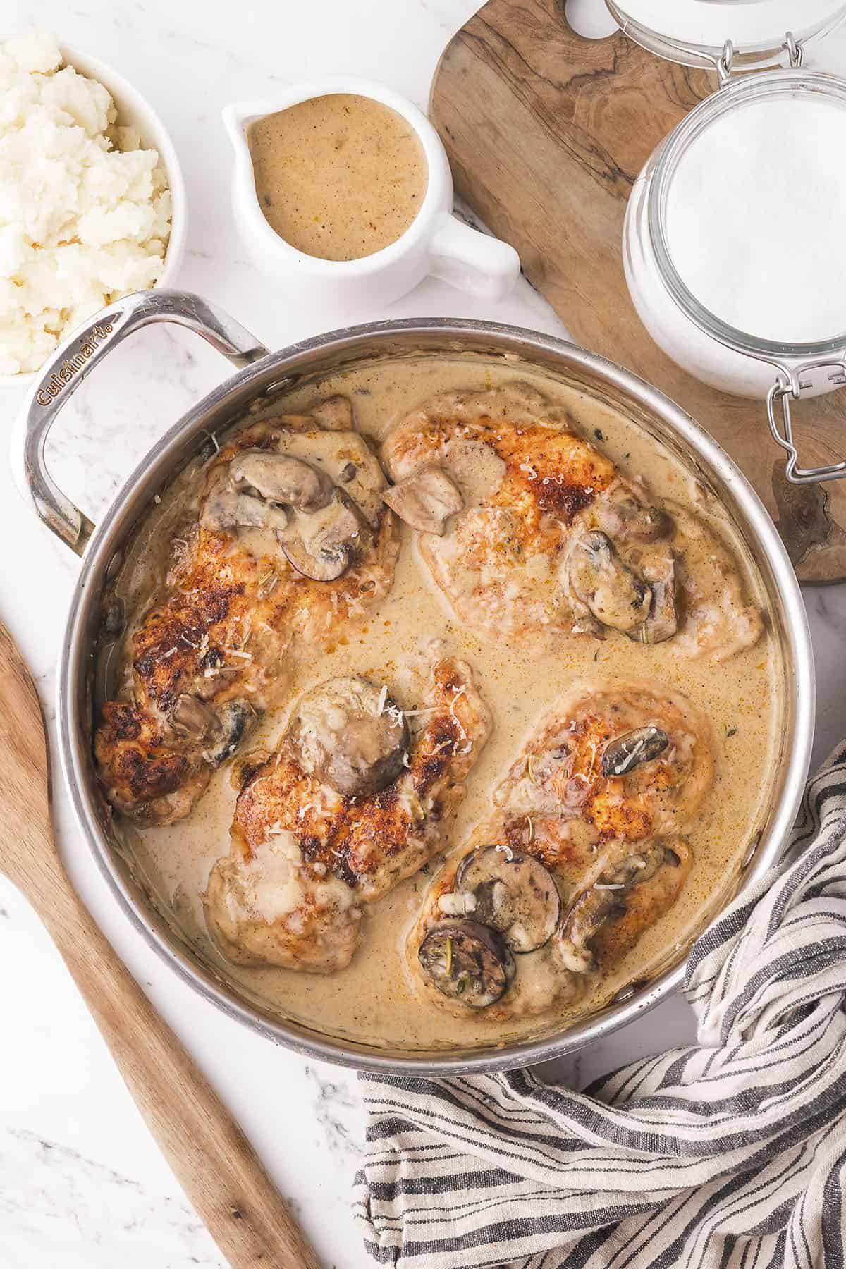 Chicken in mushroom cream sauce in skilet.