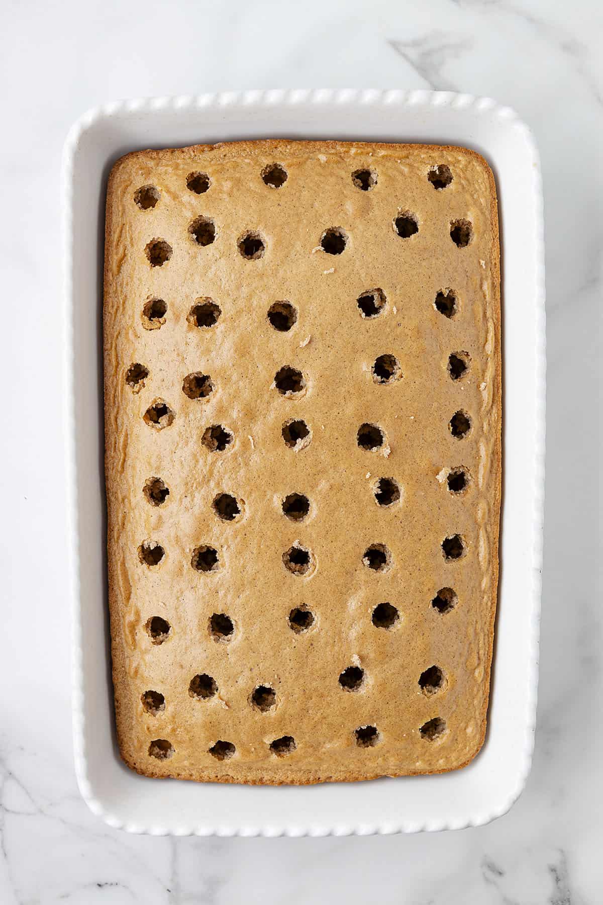 Baked cake with holes poked in it.