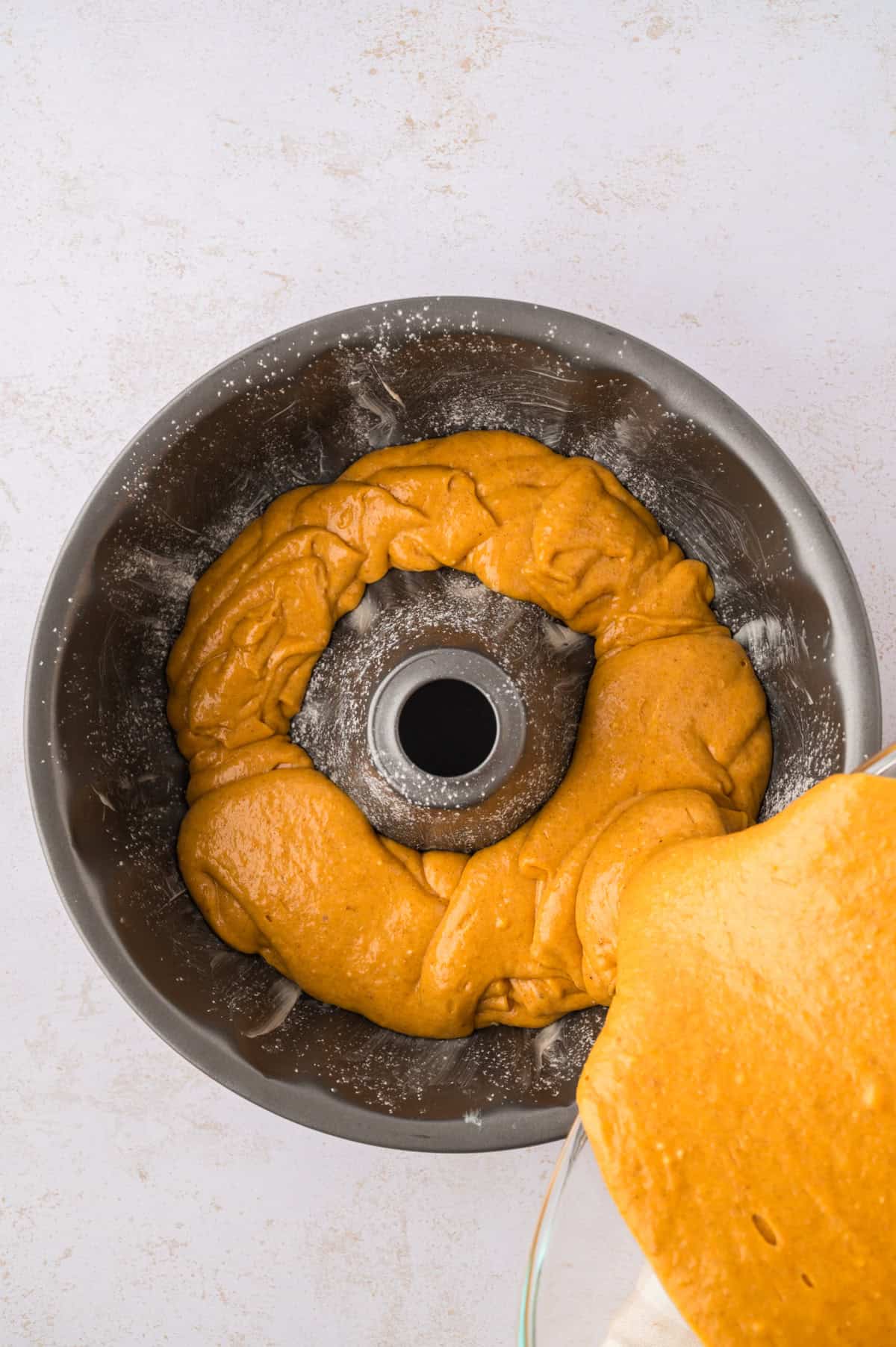 Pumpkin cake batter in bundt pan.