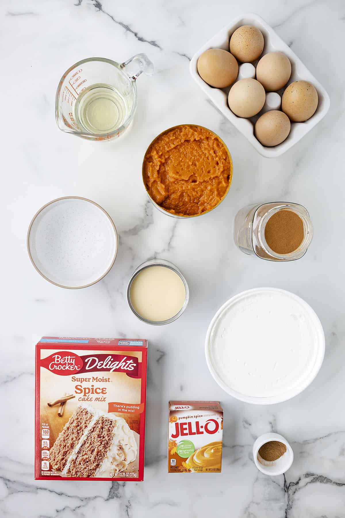 Ingredients for pumpkin poke cake on counter.