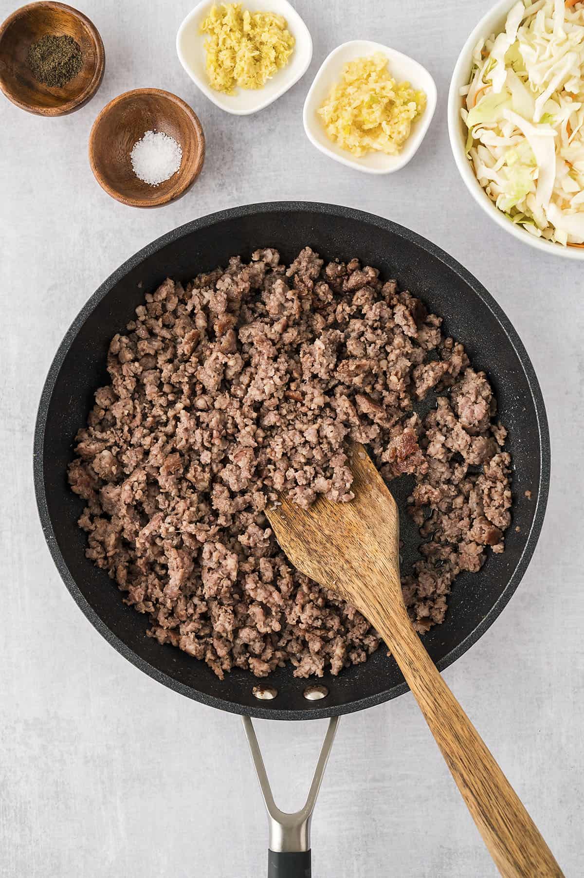 Ground sausage in skillet.