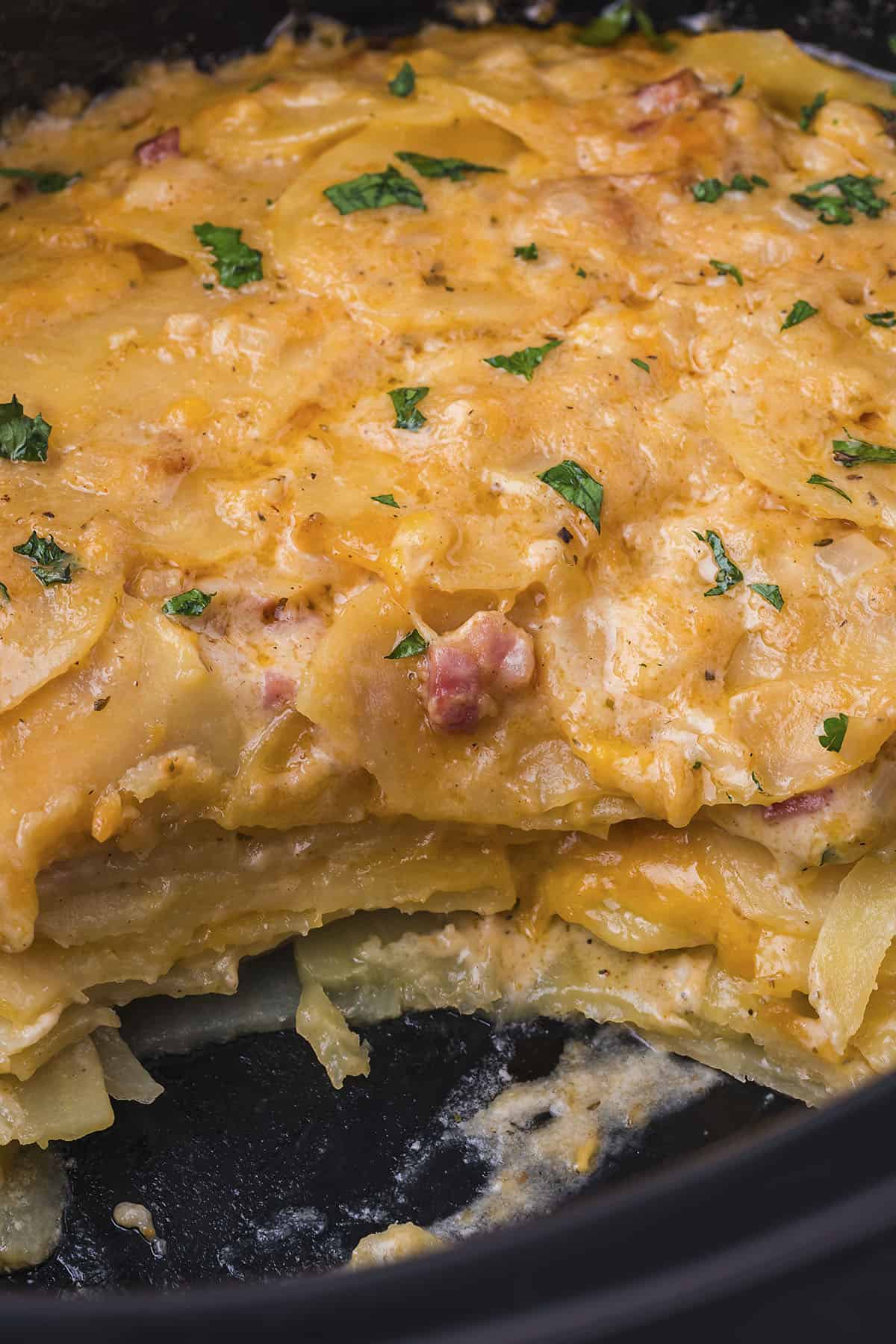 Slow cooker scalloped potatoes with ham in crockpot.