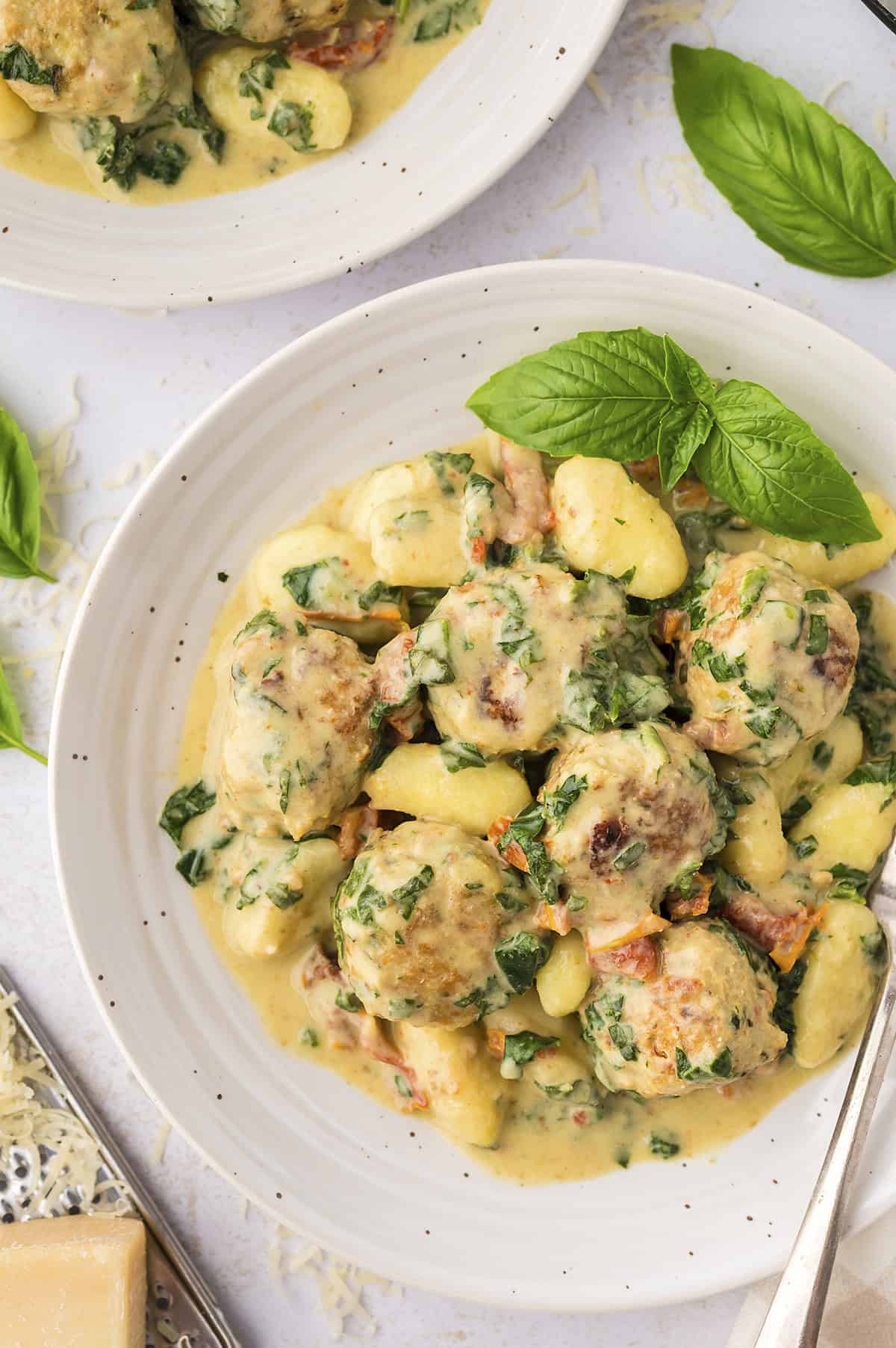 Slow cooker Tuscan chicken meatballs with gnocchi on plate.