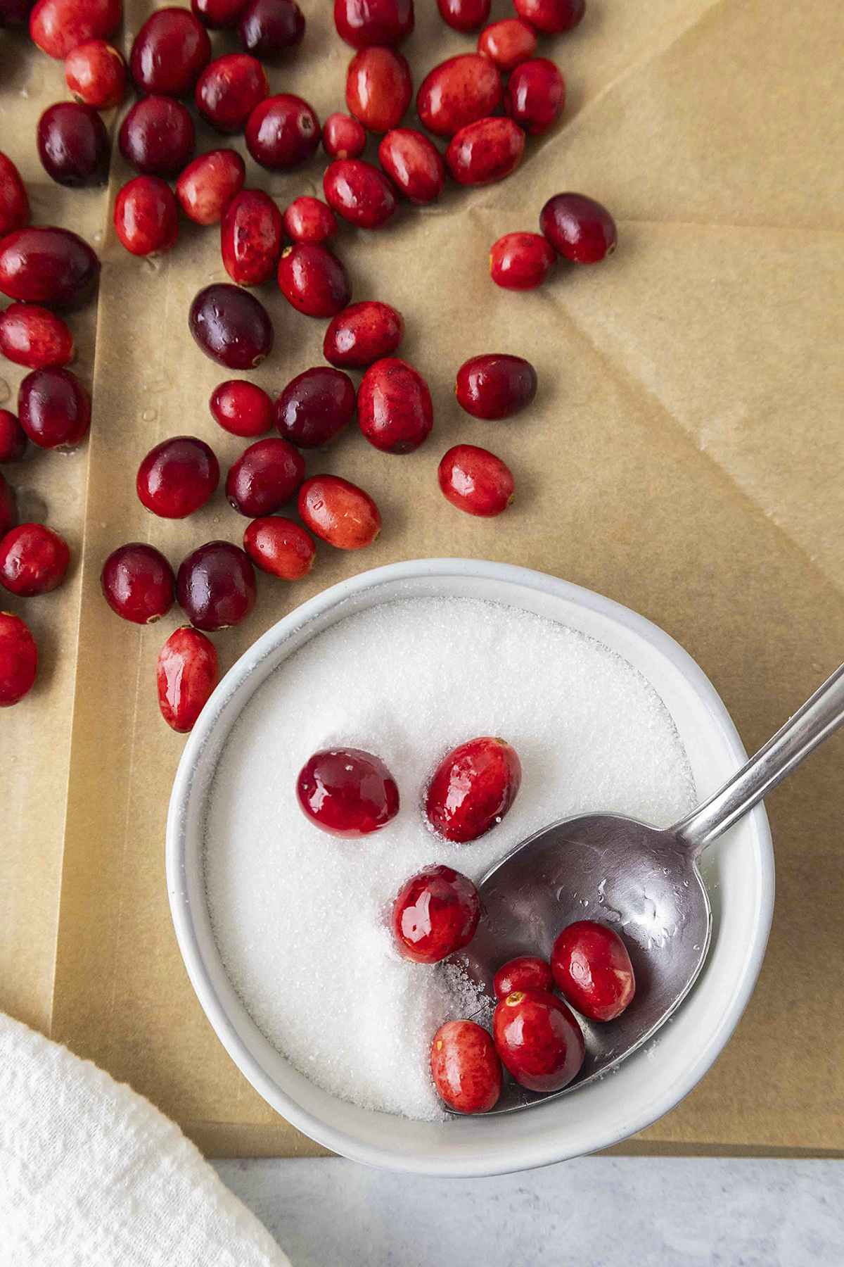 Cranberries being rolled in sugar.