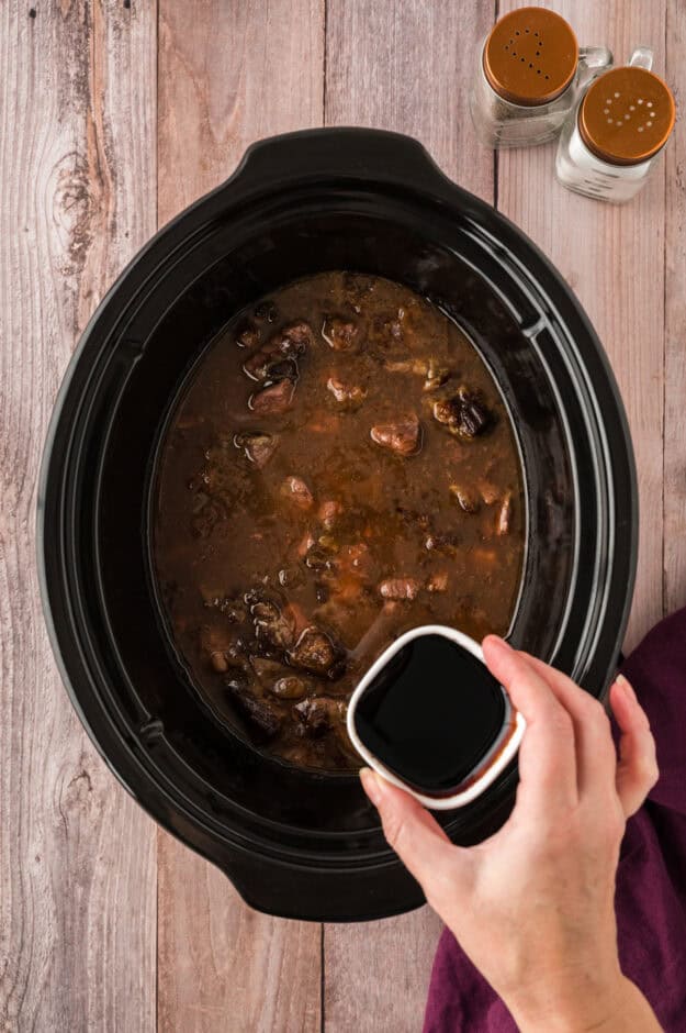 Browning sauce being added to crockpot beef tips and gravy recipe.