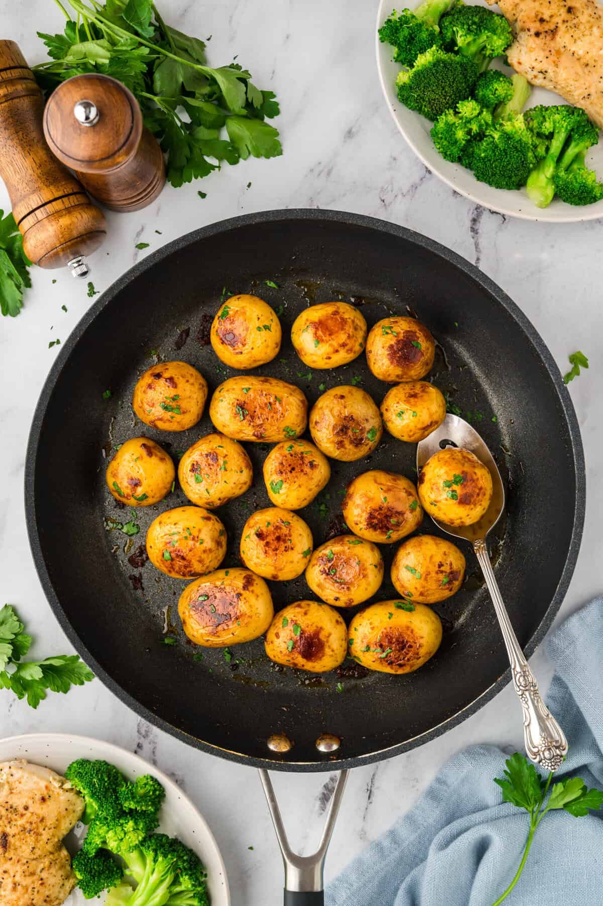 Browned boiled potatoes in skillet.