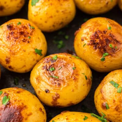 Boiled potatoes with crispy outsides in pan.