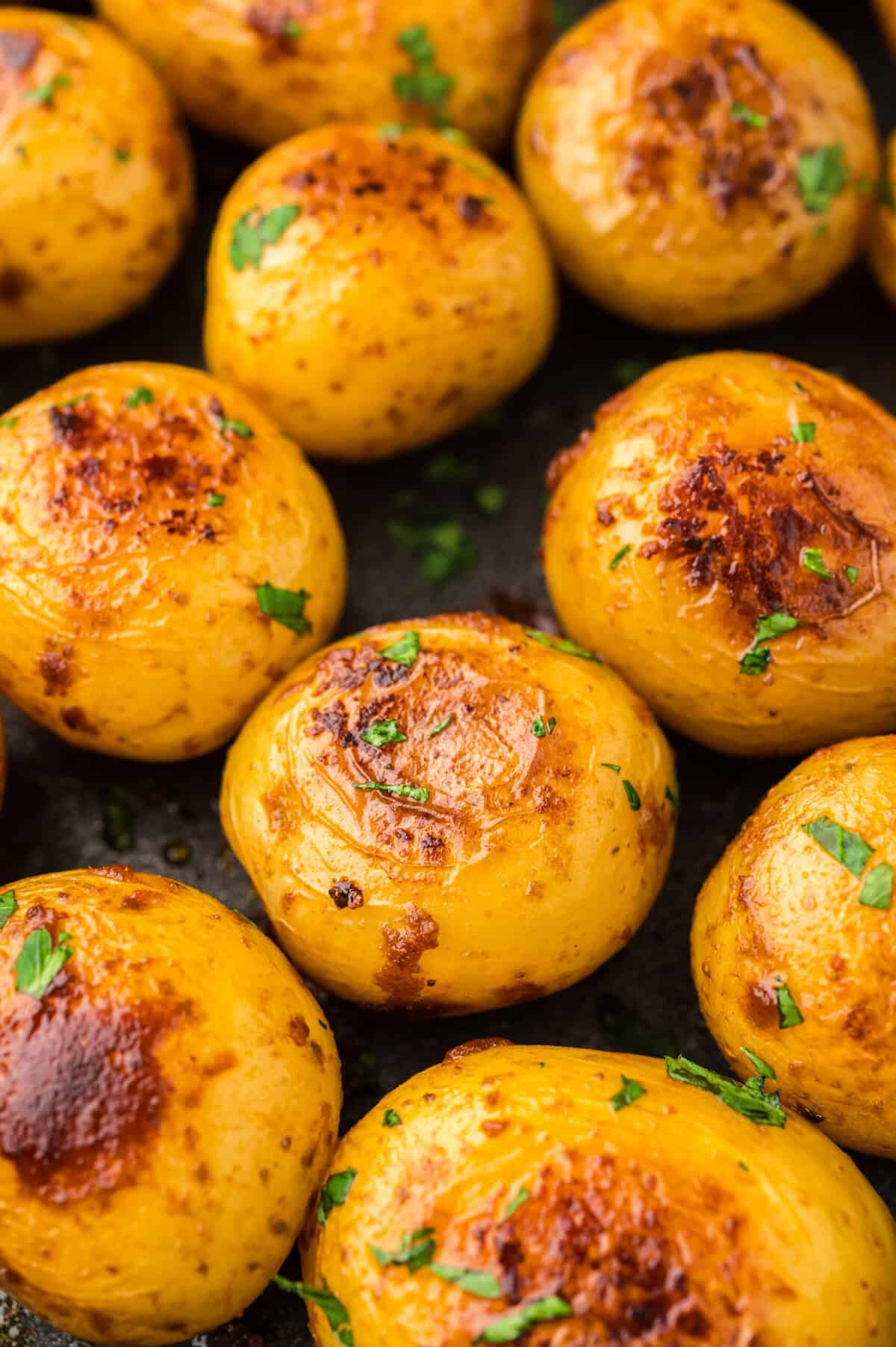 Boiled potatoes with crispy outsides in pan.