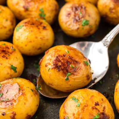 Browned baby yellow potatoes in skillet.