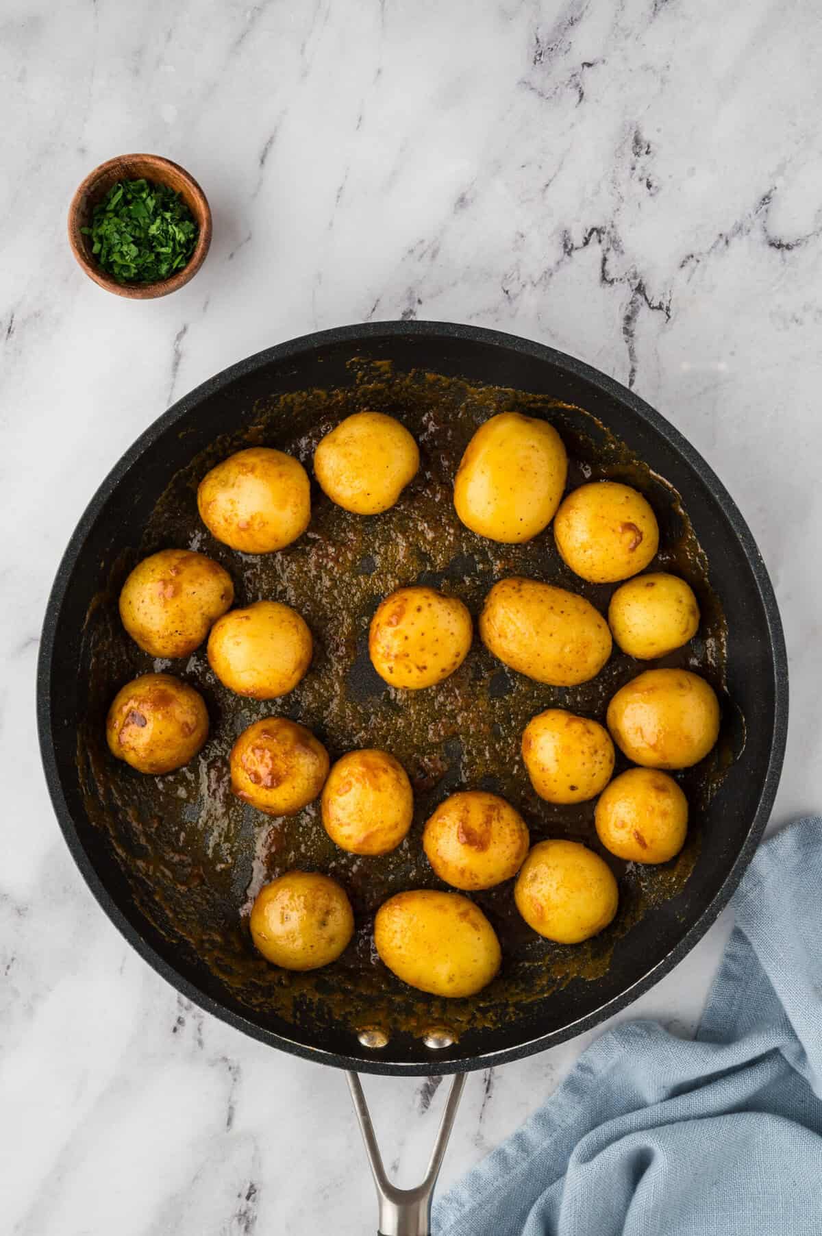 Browned potatoes in skillet.