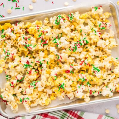 Pan full of white chocolate popcorn with Christmas sprinkles.