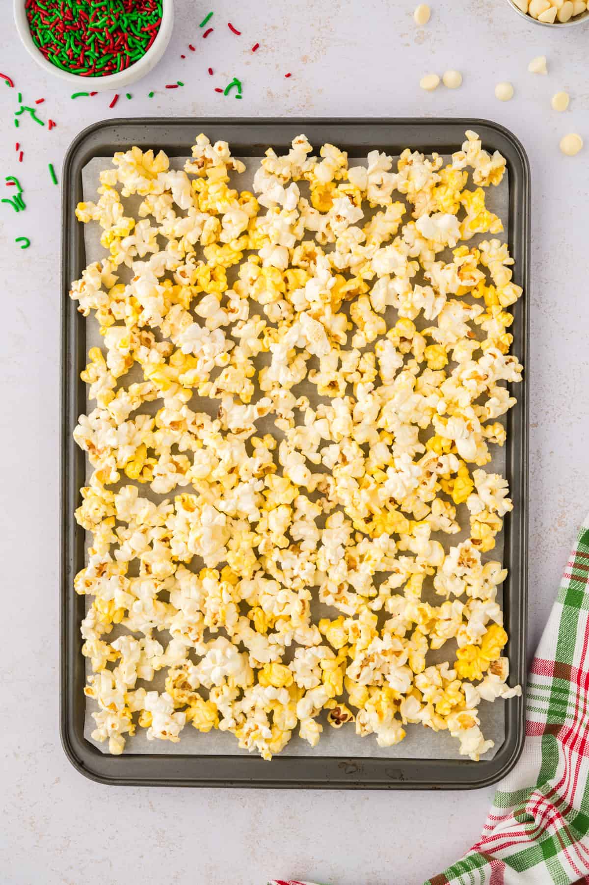 White chocolate drizzled over popcorn.