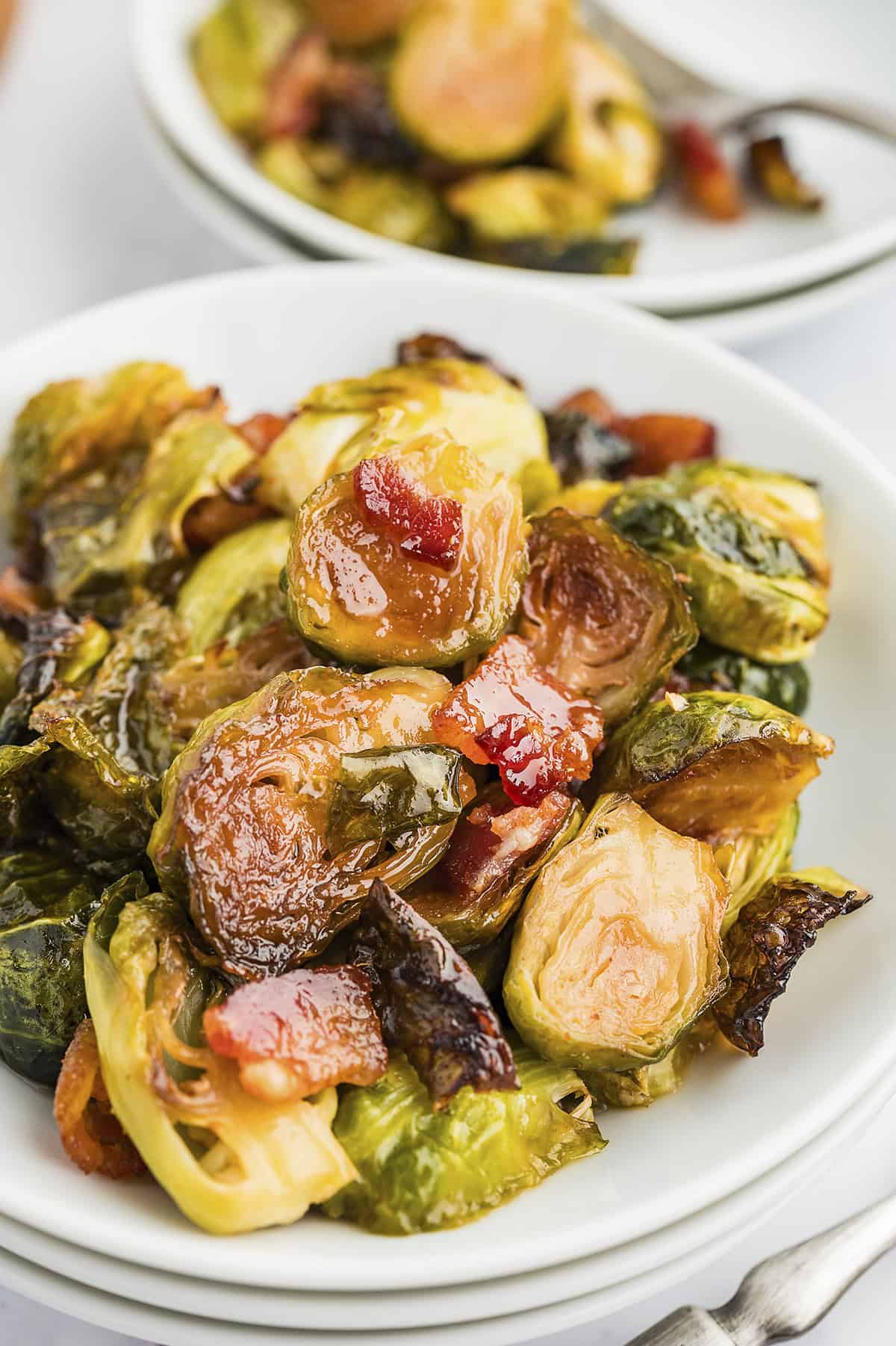 Roasted maple bacon brussels sprouts in white dish.