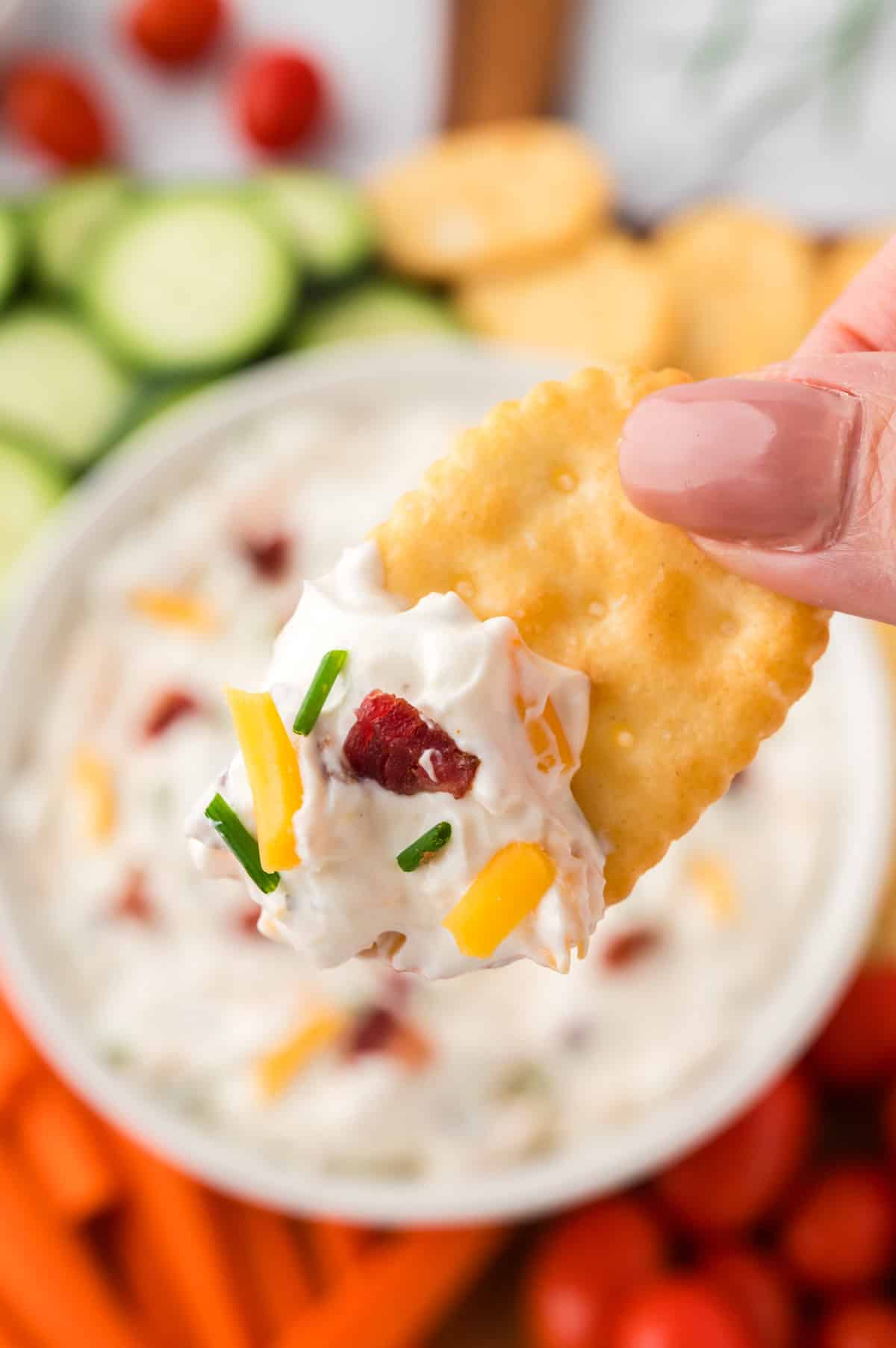 Bacon cheddar ranch dip on cracker.