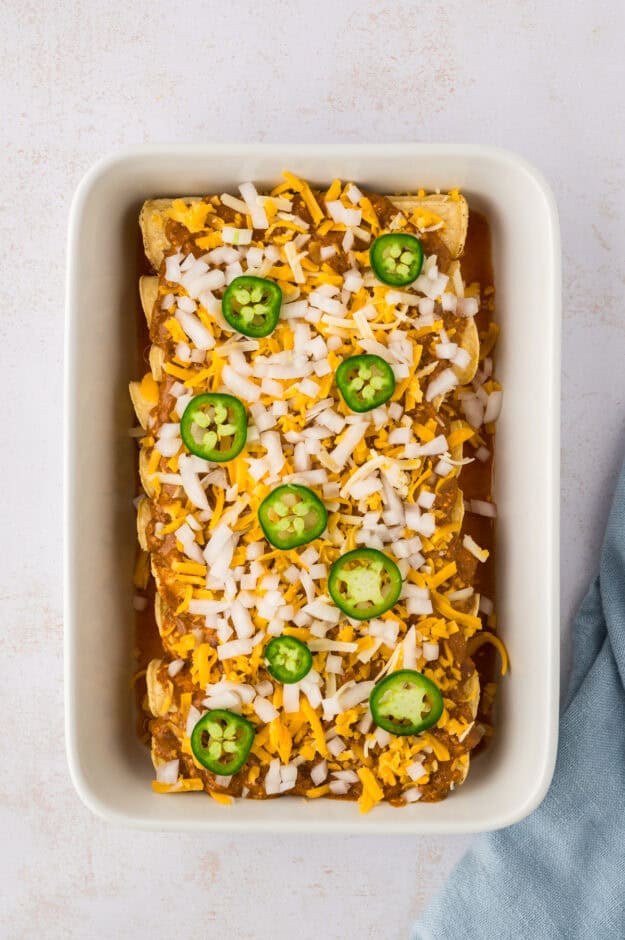 Chili cheese enchiladas in baking dish.