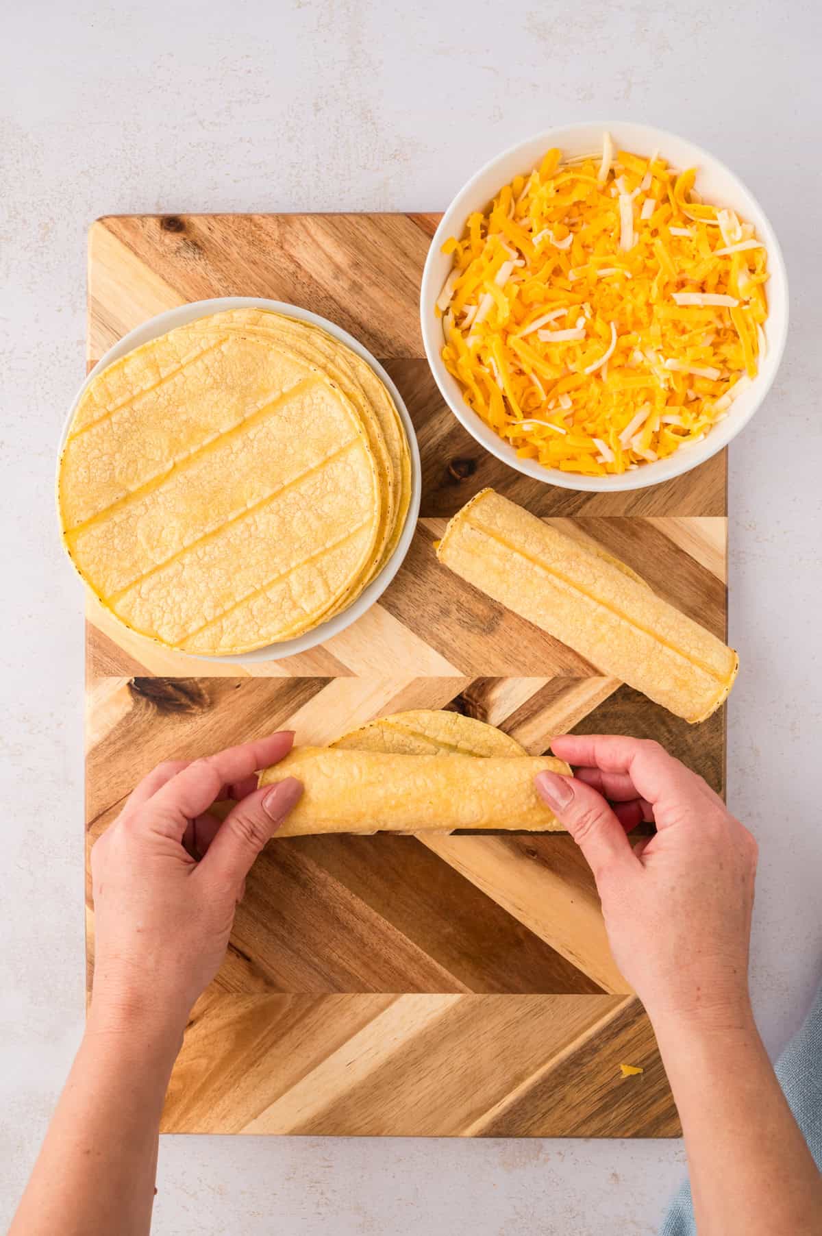 Cheese enchiladas being rolled.