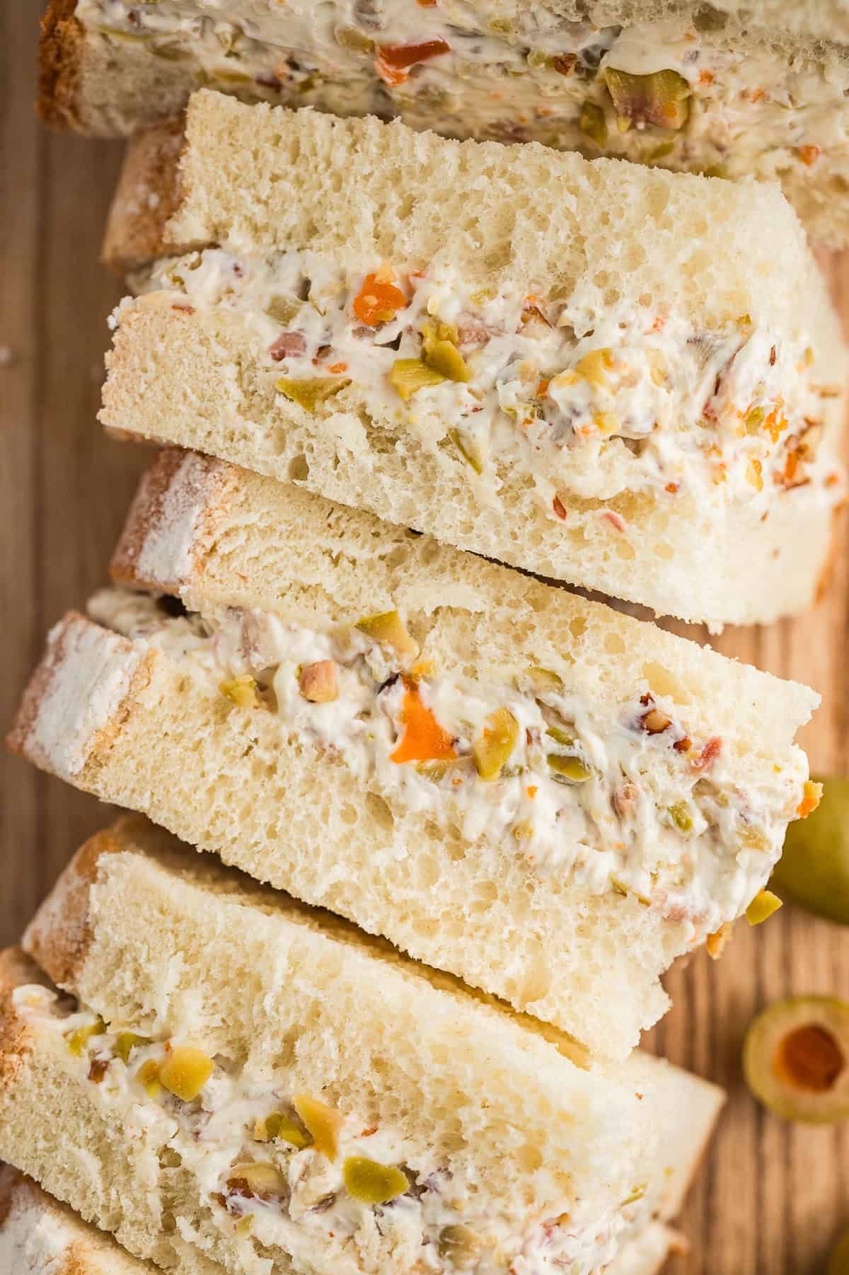 Olive spread between white bread.