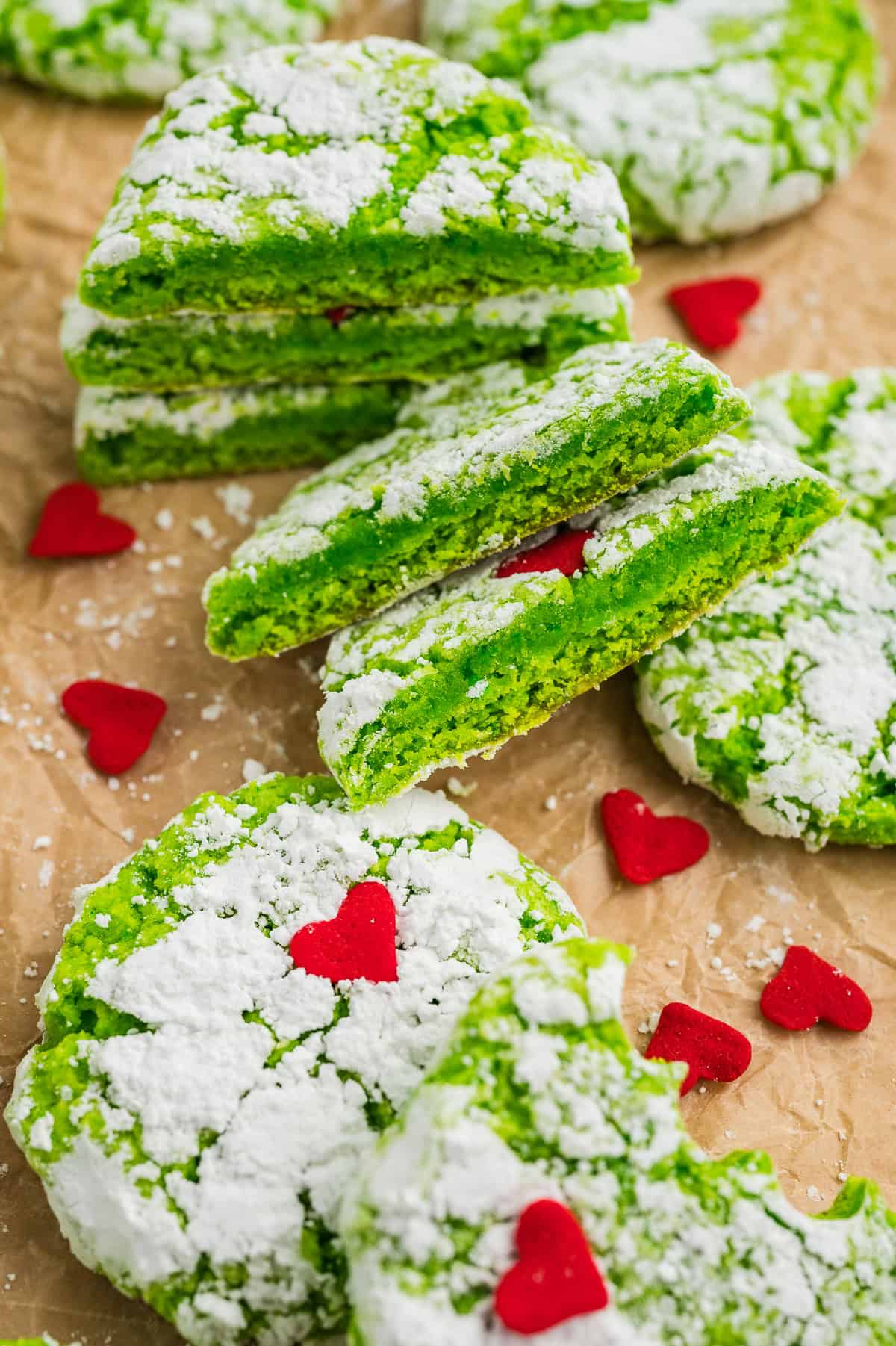 Grinch cookies piled on parchment paper.