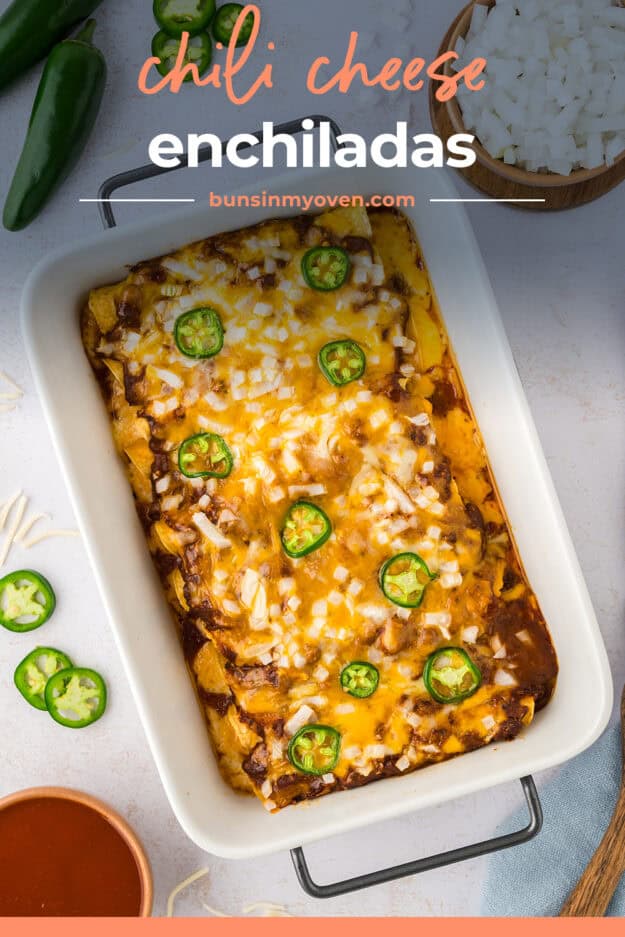 Casserole dish full of cheese enchiladas topped with chili.