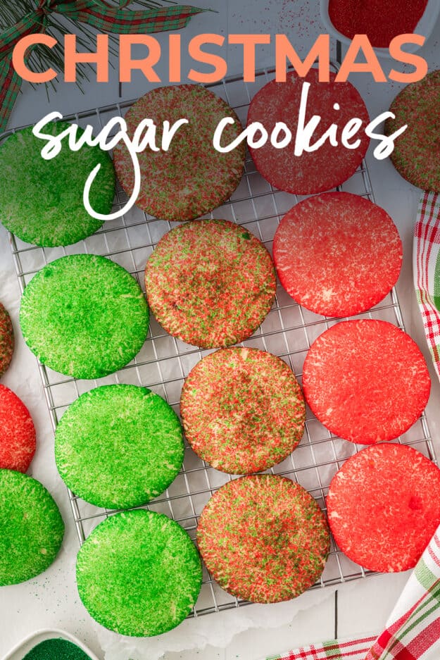 Christmas sugar cookies lined up on cooling rack.