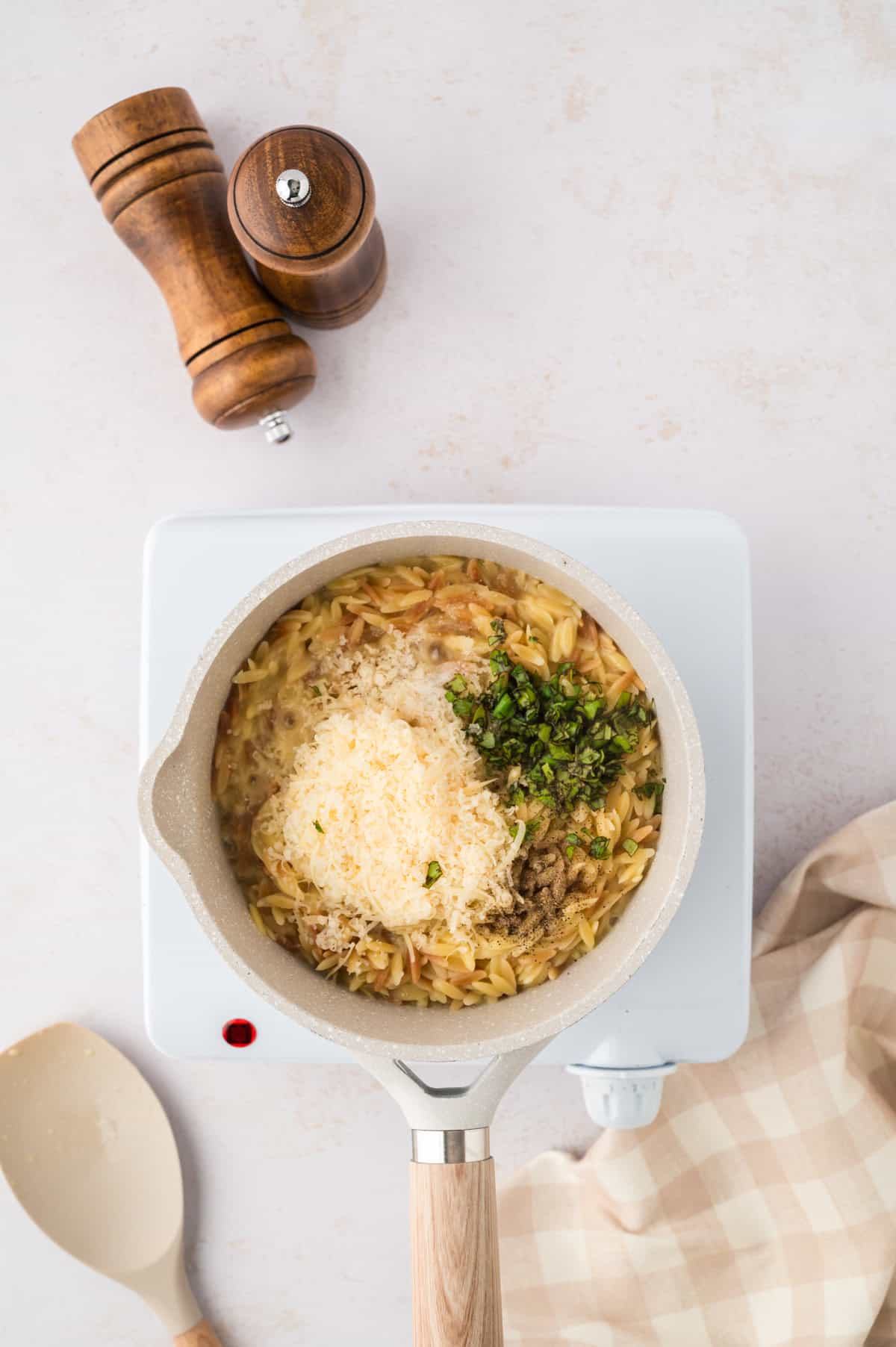 Ingredients for parmesan orzo in saucepan.