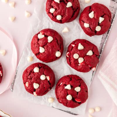 Thick red velvet cake cookies on cooling rack.