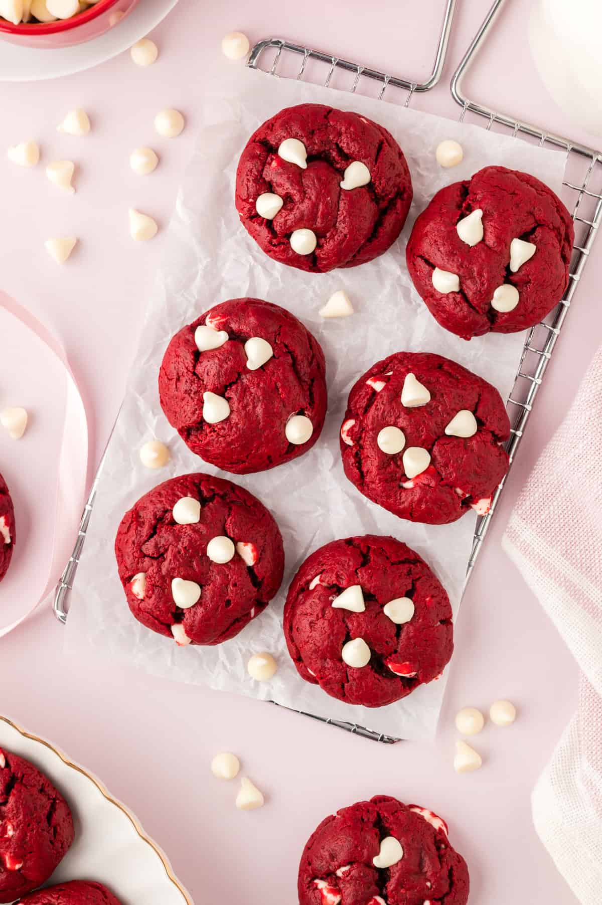 Thick red velvet cake cookies on cooling rack.