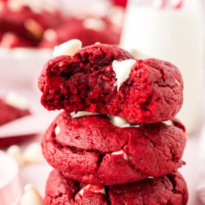 Red velvet cake cookies with a bite taken out.