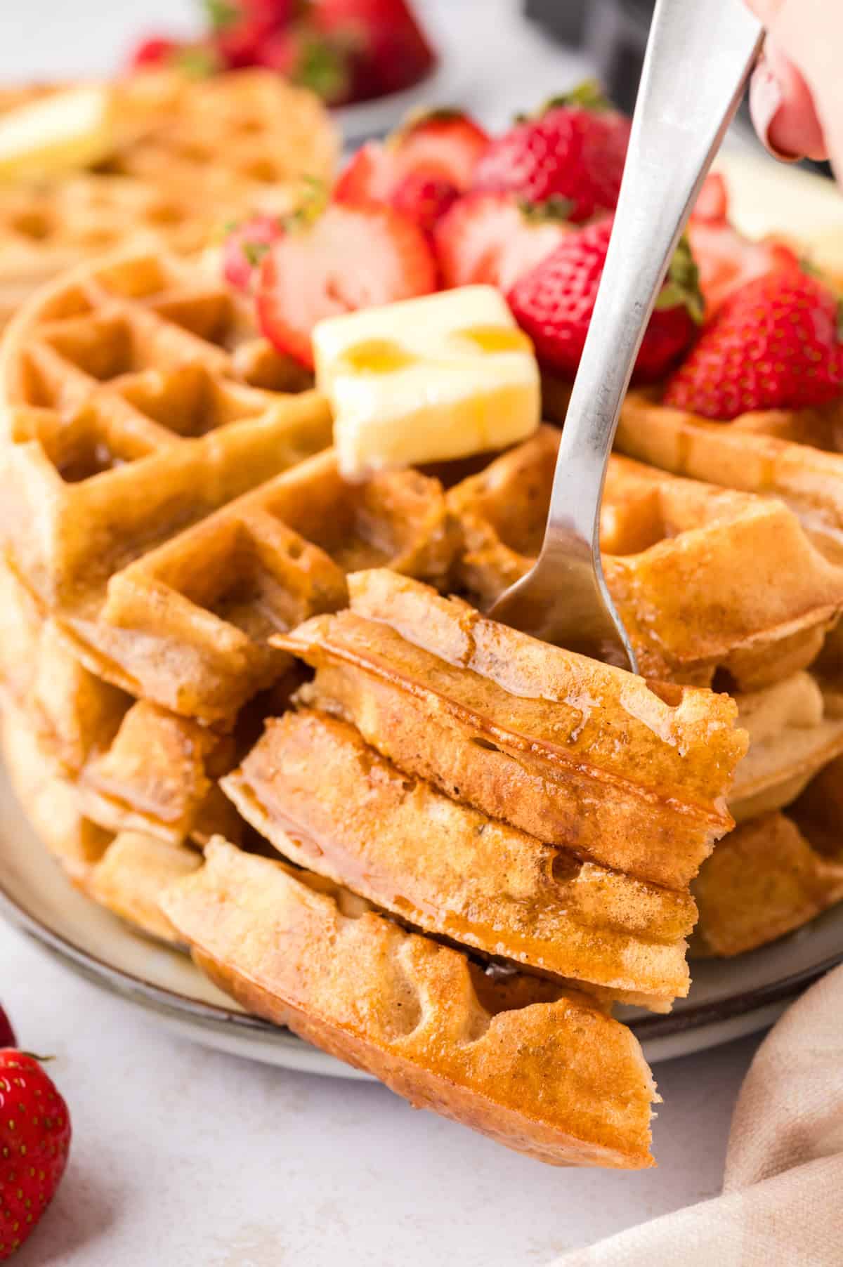 Plate full of Belgian waffles.